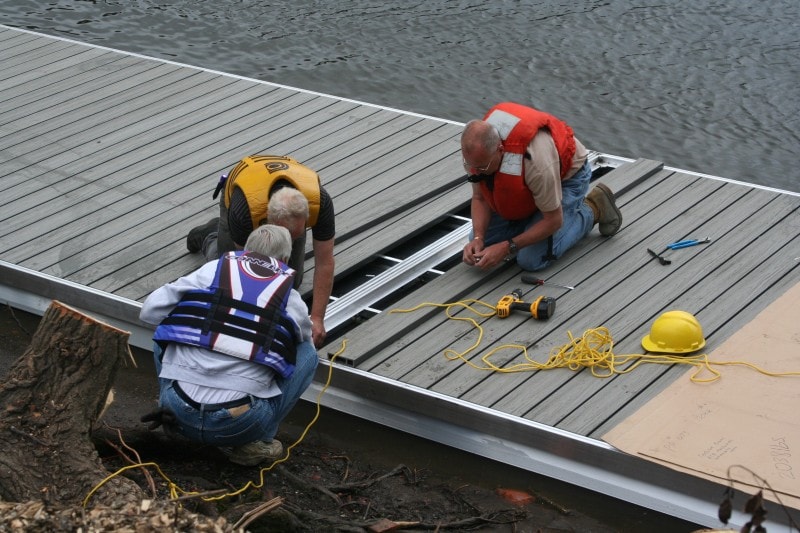 TechniDock aluminum composite rowing dock sections being assembled on shore before launch