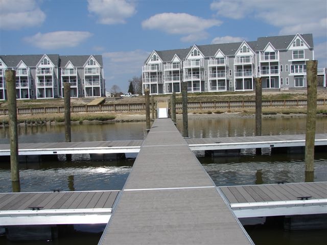 TechniDock aluminum composite floating dock with finger piers serving waterfront condominiums at Angola marina