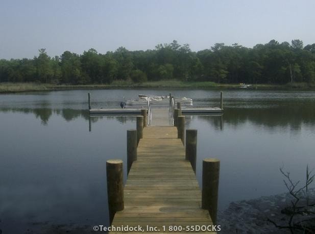 TechniDock aluminum composite floating dock with finger pier on calm river