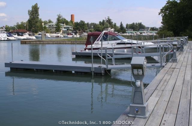 TechniDock aluminum composite floating dock with power pedestals and boat slips at marina
