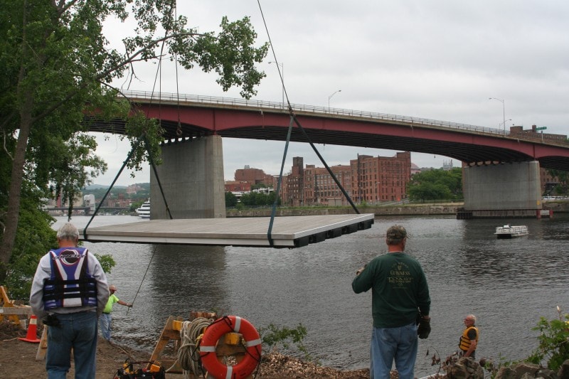 TechniDock large aluminum composite rowing dock being craned into position on river