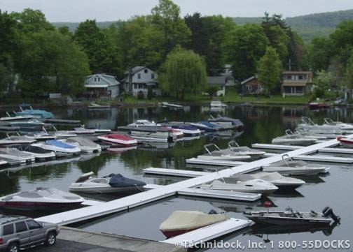 TechniDock commercial aluminum floating dock marina with boats and residential homes