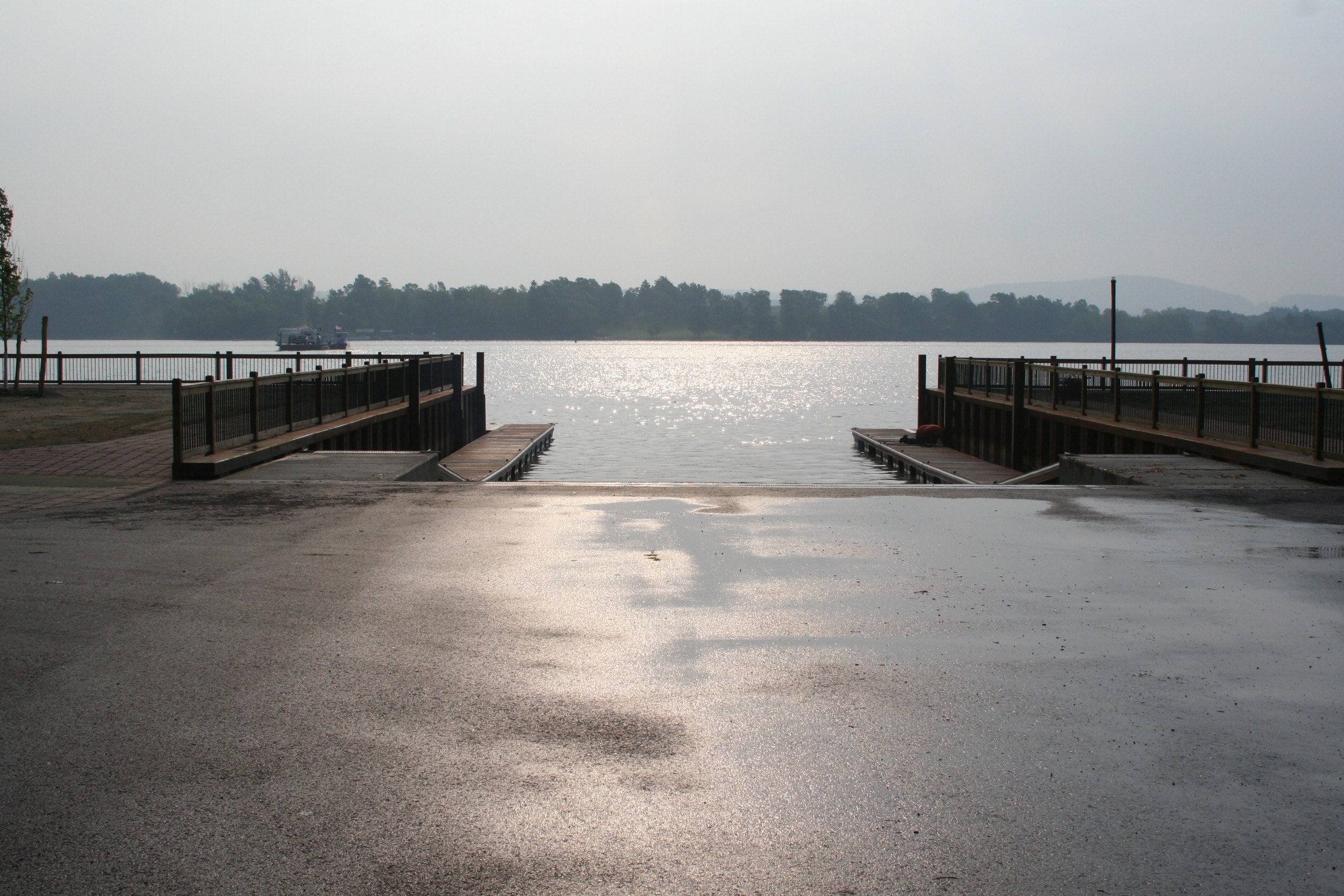 TechniDock boat launch docks with aluminum railings and ramps leading into a calm lake
