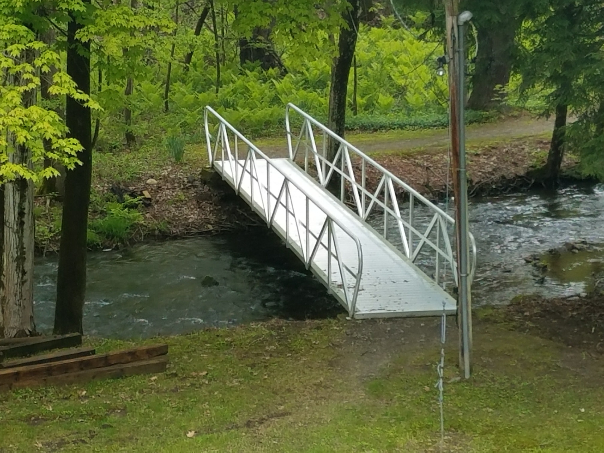 TechniDock aluminum gangway bridge over wooded stream